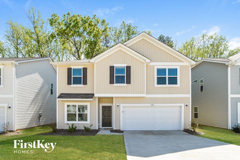 a beige and white house with a garage door