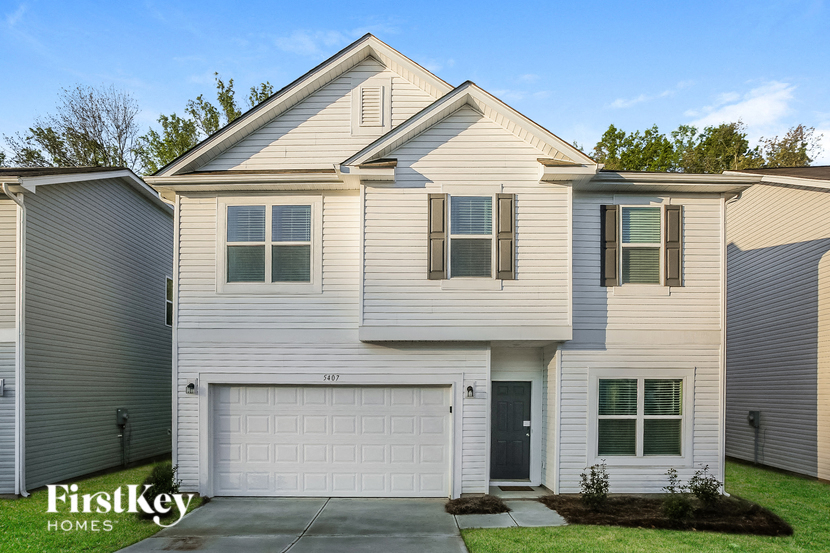 a white house with a white garage door