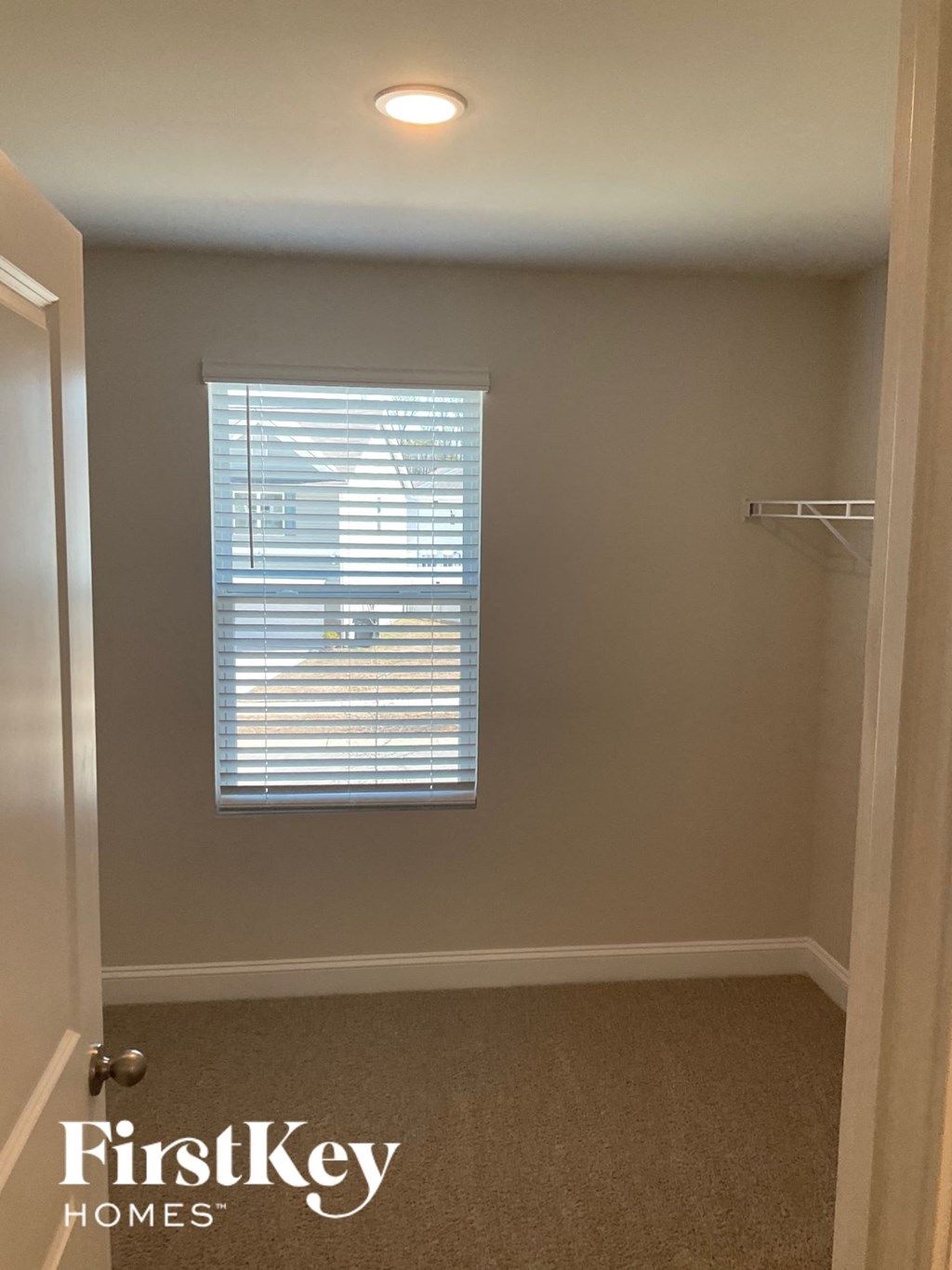 a small bathroom with a window and a closet