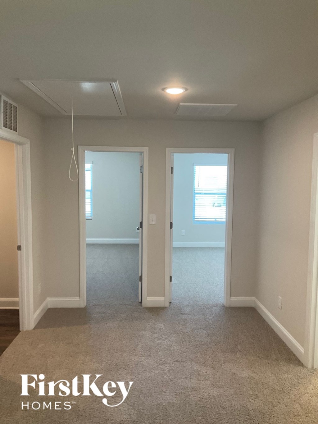 an empty room with two doors and a window