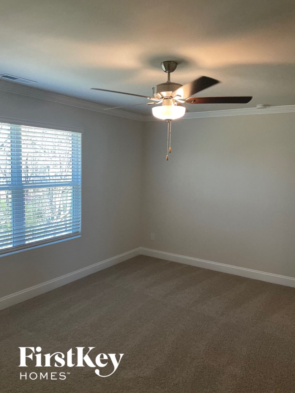 a bedroom with a ceiling fan and a window