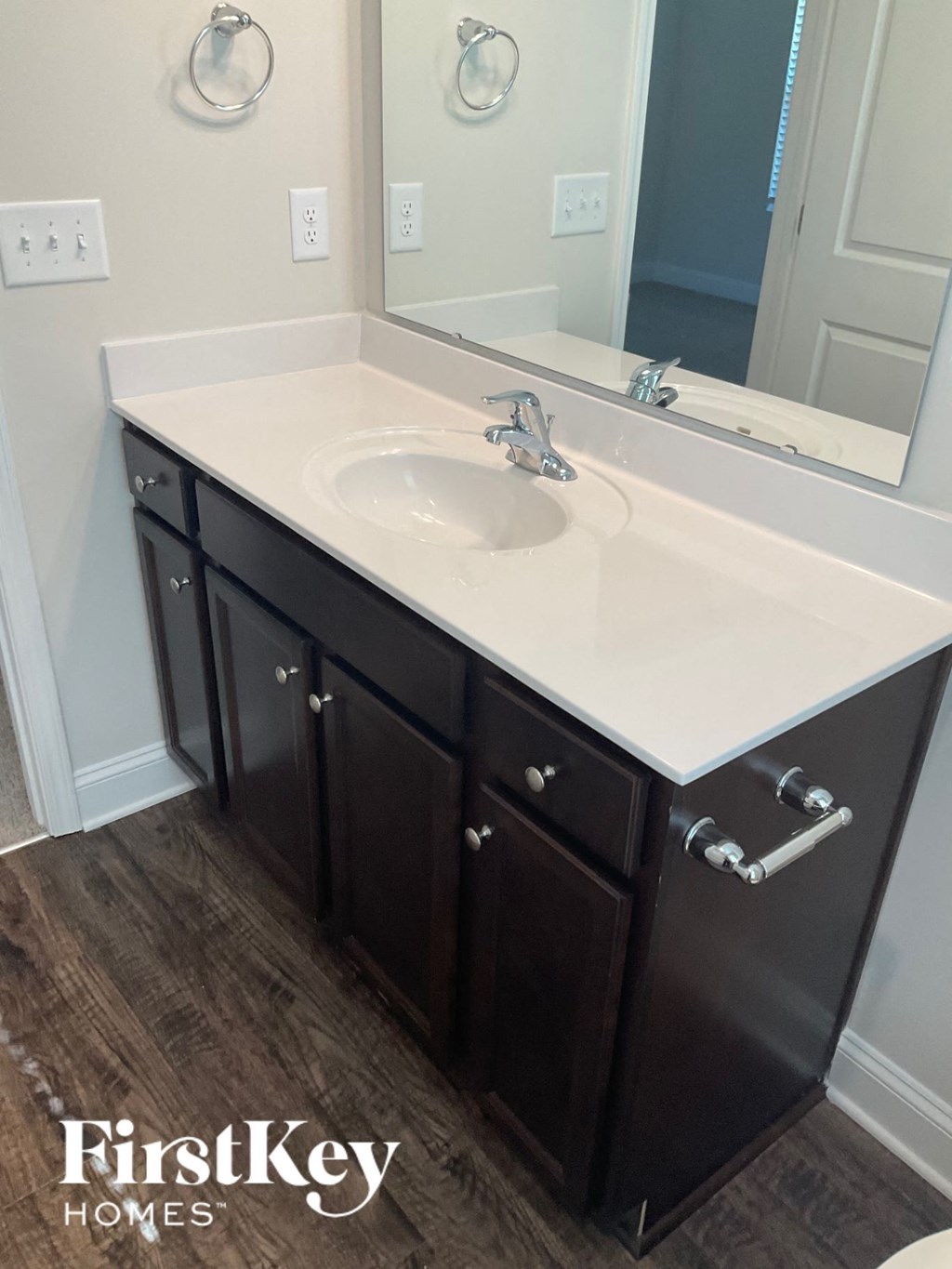 a bathroom with a white sink and a mirror
