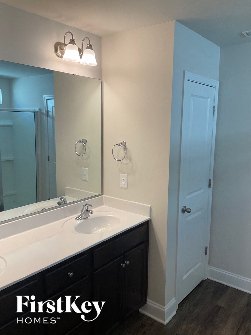 a white bathroom with a sink and a mirror