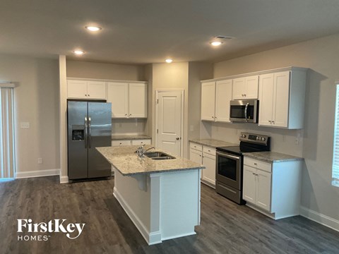 A kitchen with a FirstKey Homes logo.