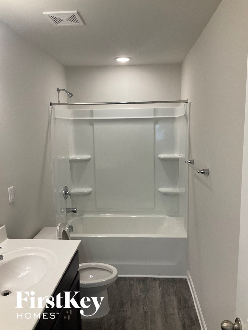 a bathroom with a shower and a toilet and a sink