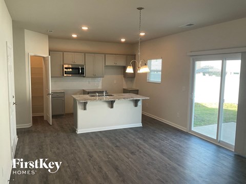 an empty kitchen with an island in the middle of it