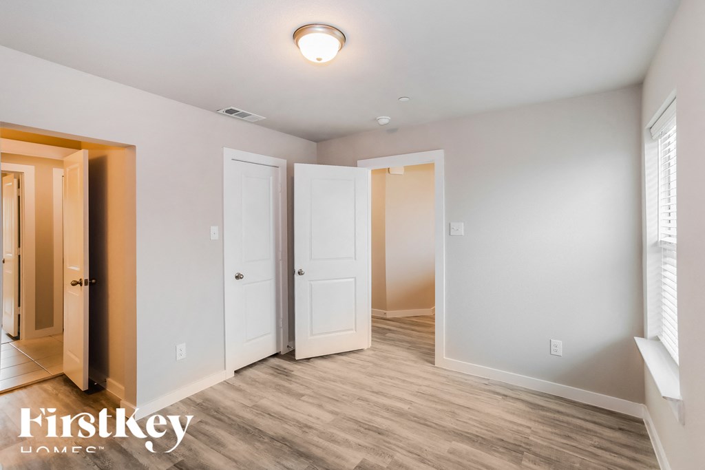 a bedroom with two closets and a door to a bathroom