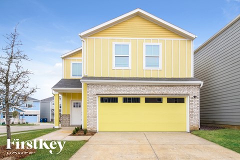 a yellow house with a yellow garage door