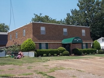 a brick building with a green awning in front of it