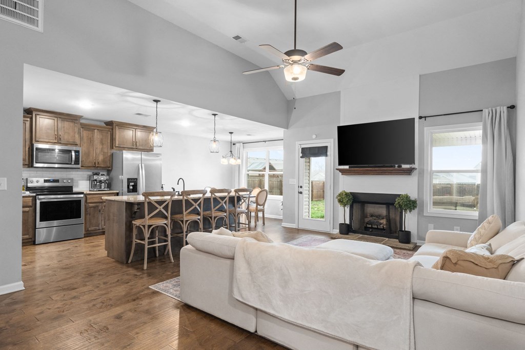 an open living room and kitchen with a couch and a tv