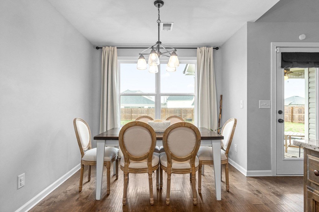 a dining room with a table and chairs and a window