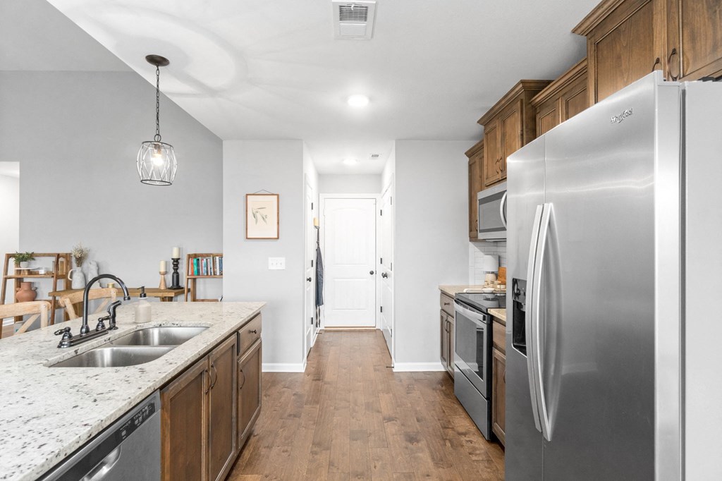 a kitchen with stainless steel appliances and wooden cabinets