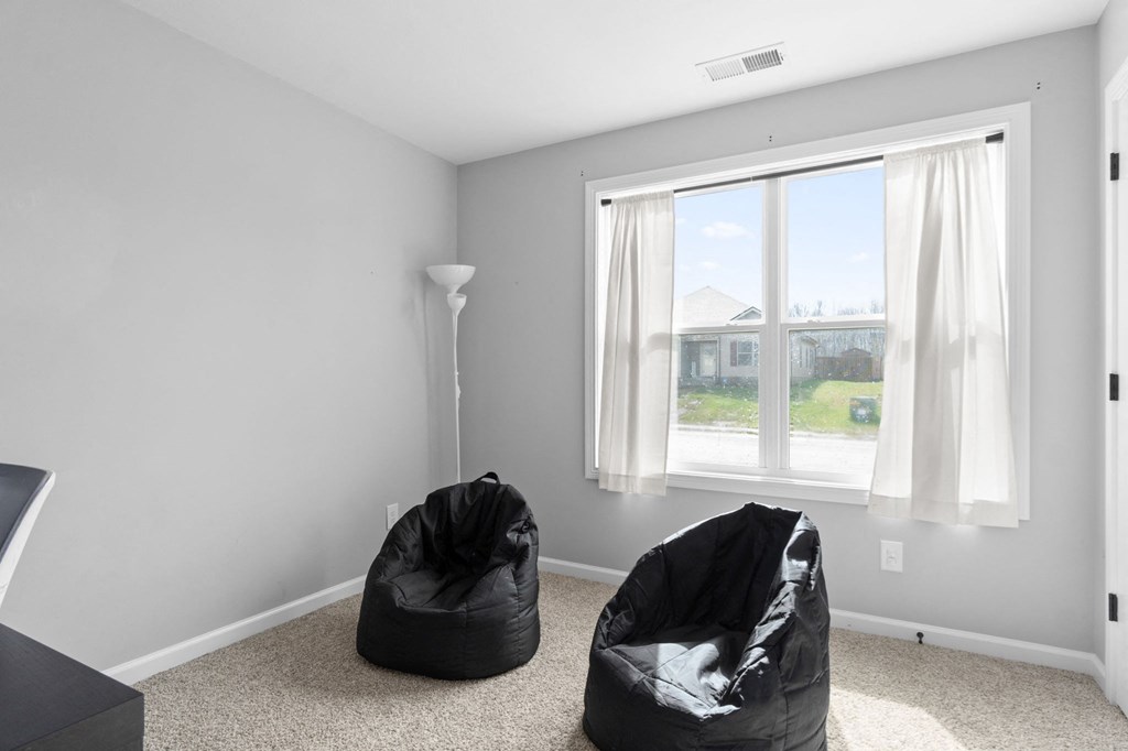 a living room with two bean bags in front of a window