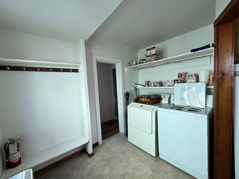 A small kitchen with a white fridge and a white dishwasher.