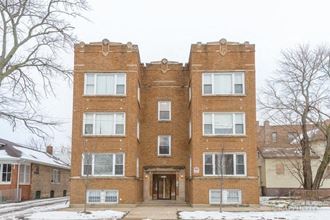 a brick building with snow in front of it
