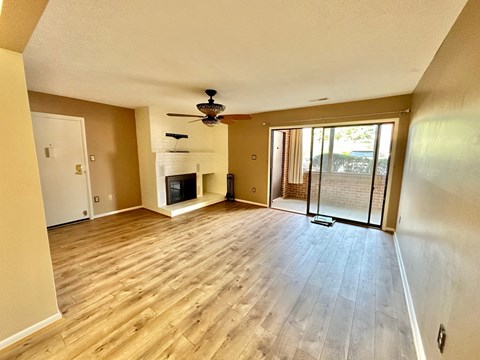 A living room with a fireplace and sliding glass doors.