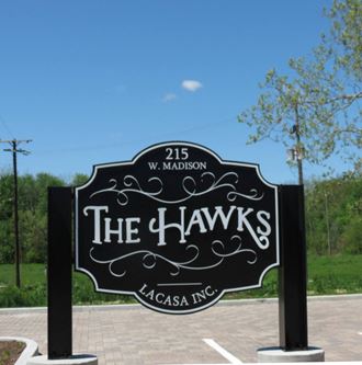 a sign that reads the hawks in front of a parking lot