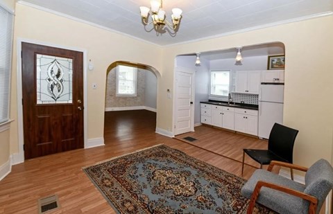 a living room and a kitchen with a rug