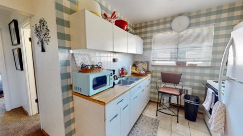a small kitchen with a microwave and a sink