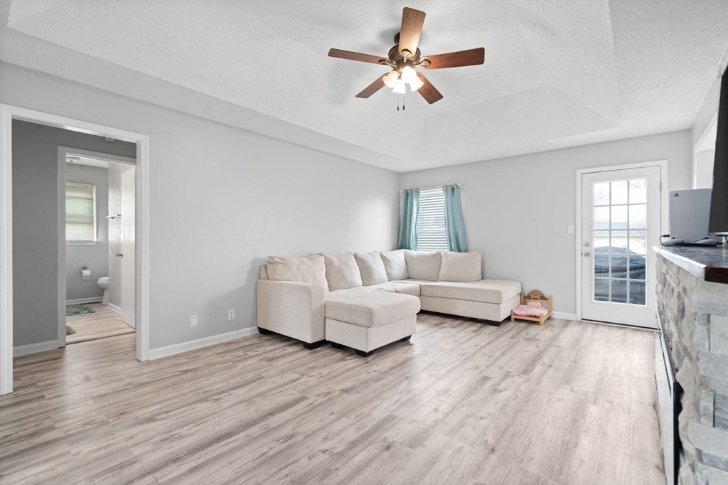 a living room with a couch and a ceiling fan