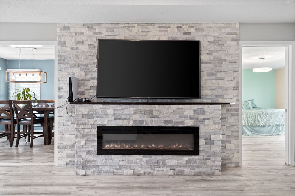 a fireplace with a tv above it in a living room