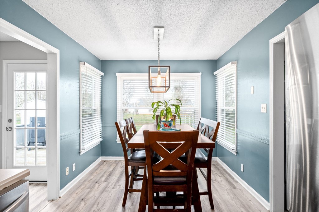 the dining room of a home with a wooden table and chairs