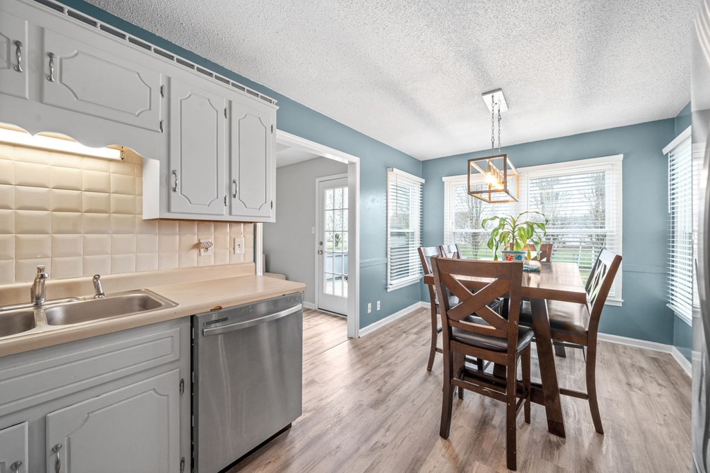 a kitchen with a table and chairs and a sink