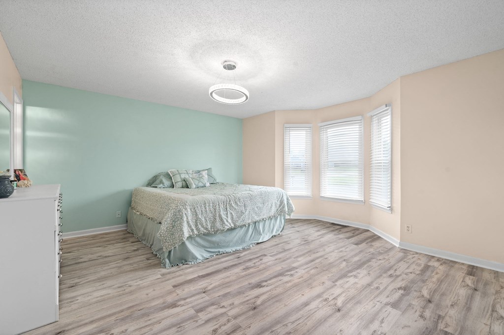 a bedroom with a bed and some windows