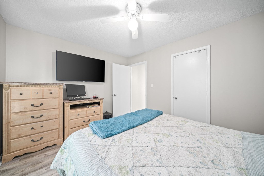 a bedroom with a bed and a tv