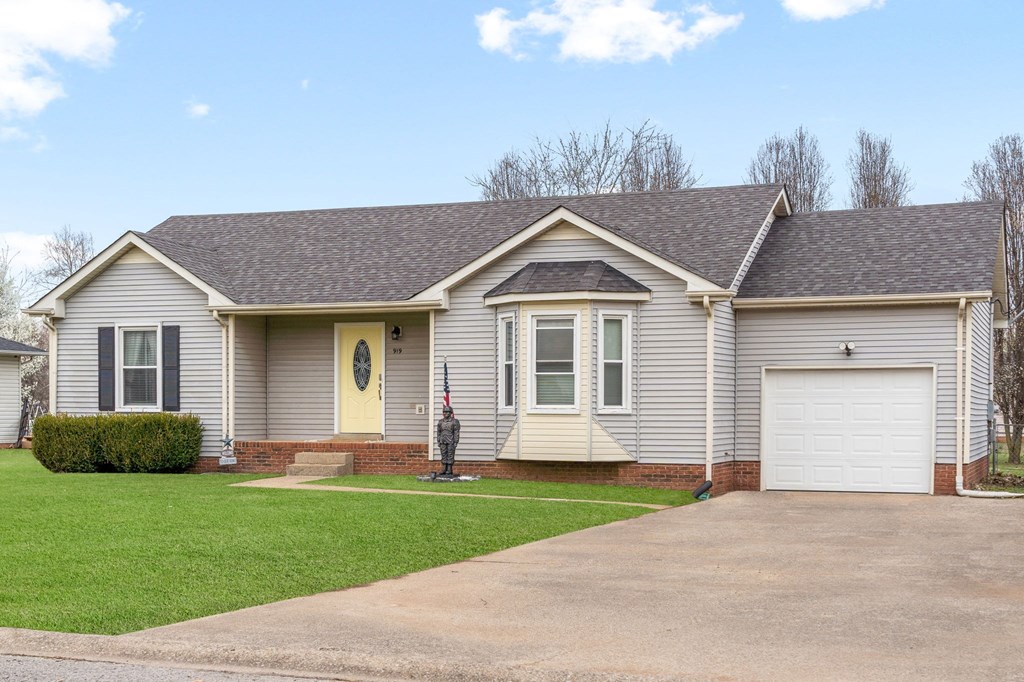 a white house with a driveway and a garage door
