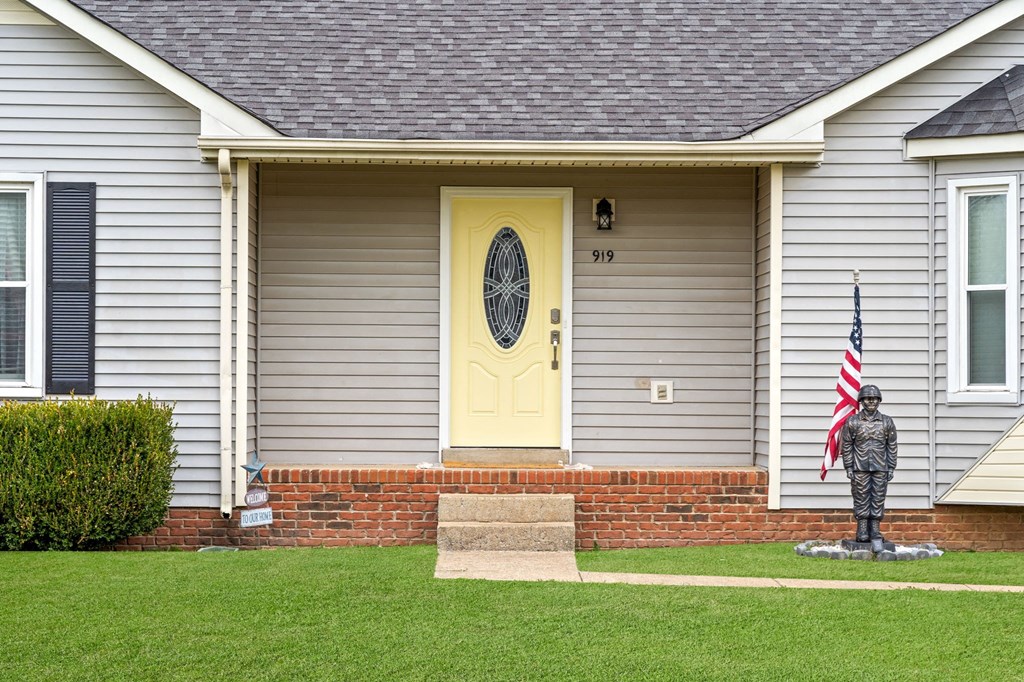 a house with a yellow door and an flag