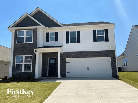 a white and gray house with a garage door
