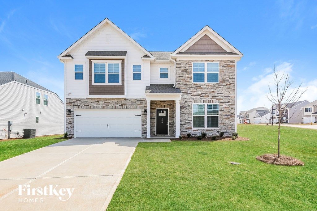 A modern two-story house with a garage is for sale by FirstKey Homes.