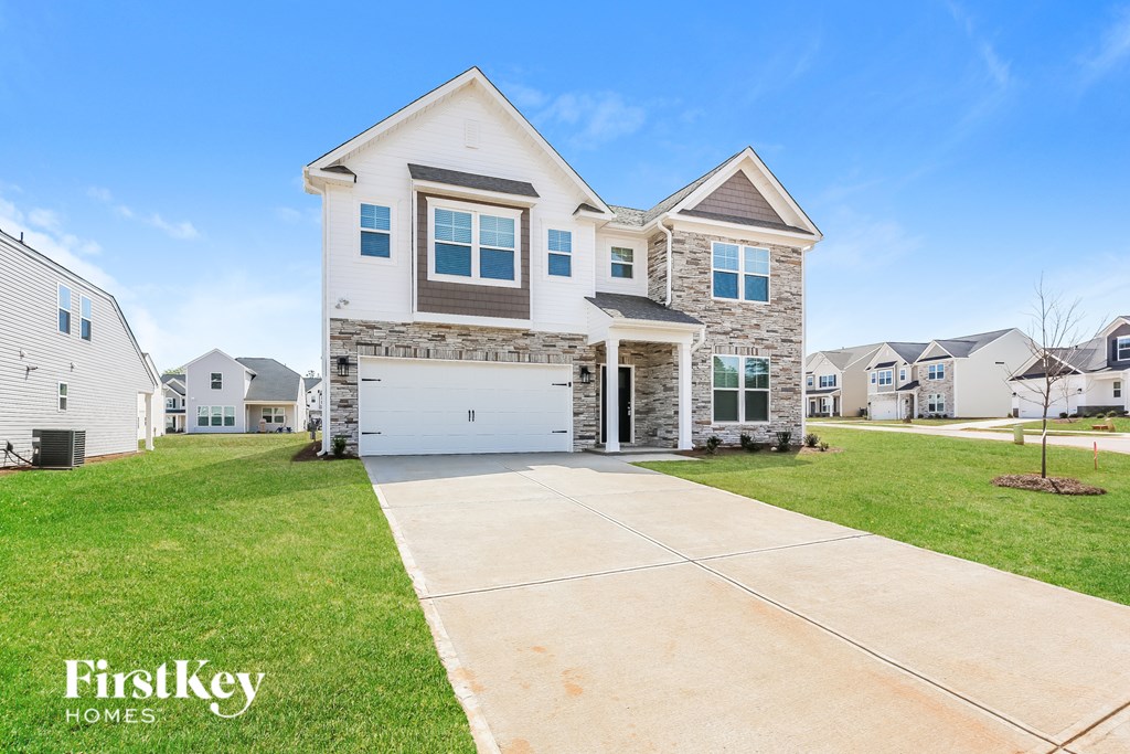 A large house with a driveway in front of it.