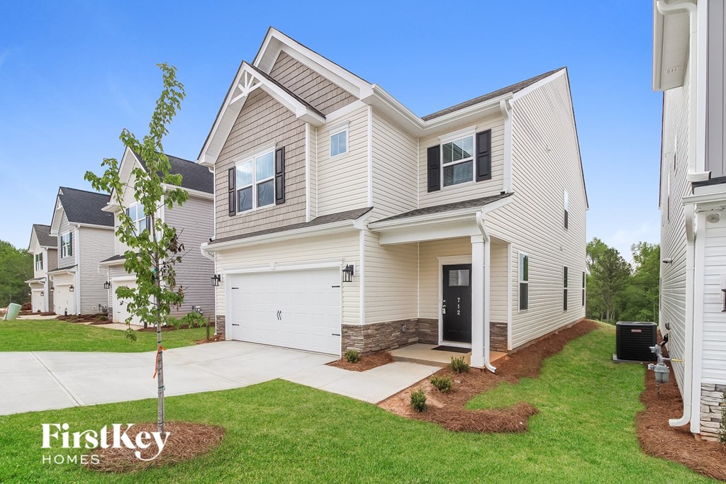 A house with a tree in front of it and the words "FirstKey Homes" on the bottom left.