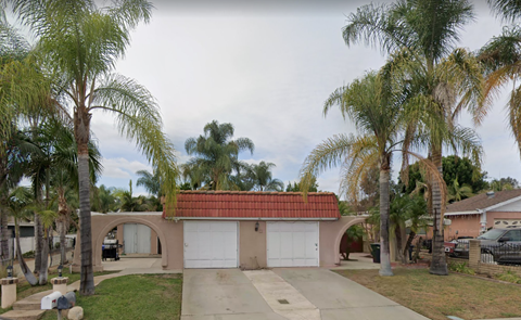 a house with palm trees in front of it