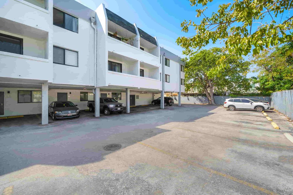 a large white building with cars parked in front of it