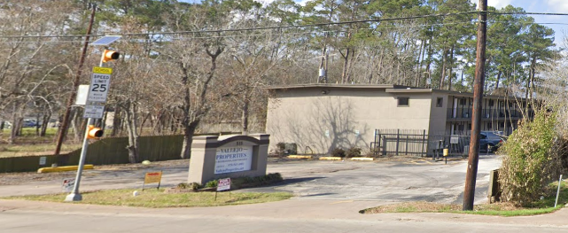 a building with a sign on the corner of a street