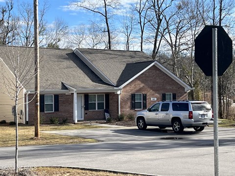 A house with a car parked in front of it.