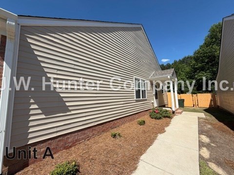 A building with a corrugated metal wall and a sign that reads "Unit A".