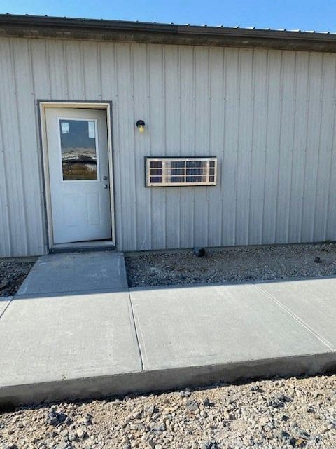 a white building with a door and a window
