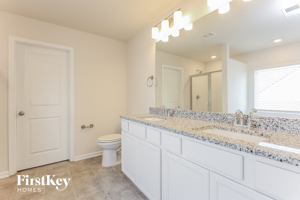 a bathroom with a toilet and a sink and a mirror