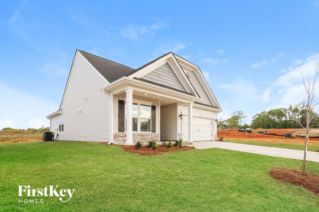 a white house with a lawn in front of it