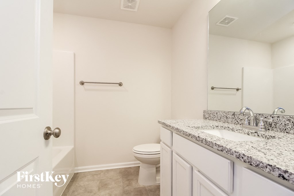 a bathroom with a toilet and a sink and a shower