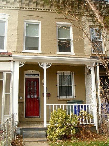 A house with a red door and a white porch.