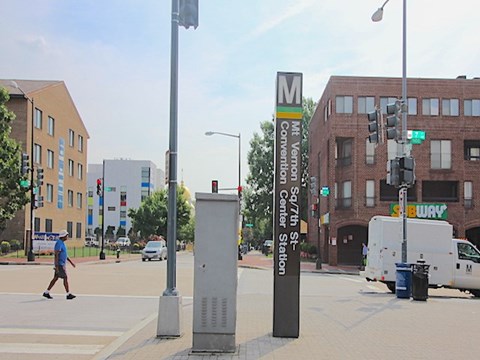 A street scene with a pedestrian crossing the road.