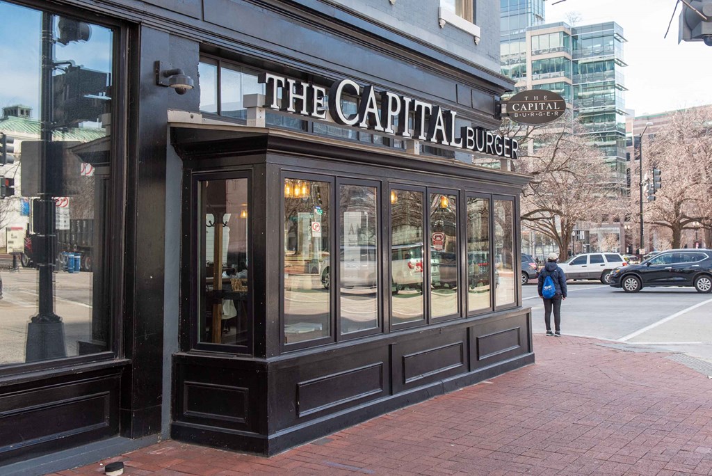 the facade of the capital espresso on the corner of a city street