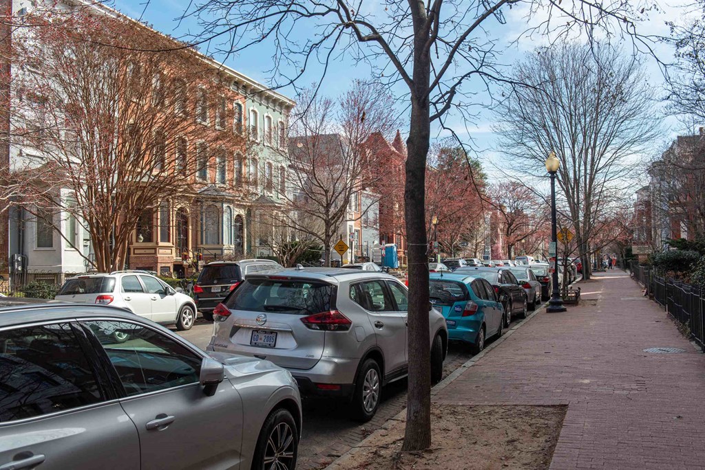 a row of cars parked on a city street