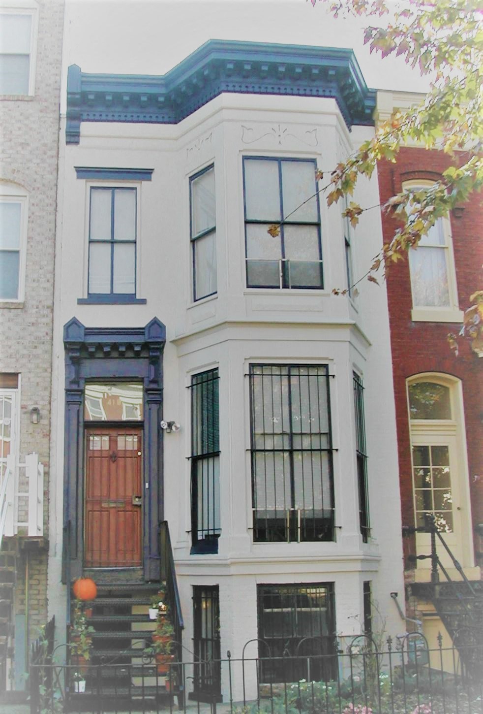 the front of a house with a red door