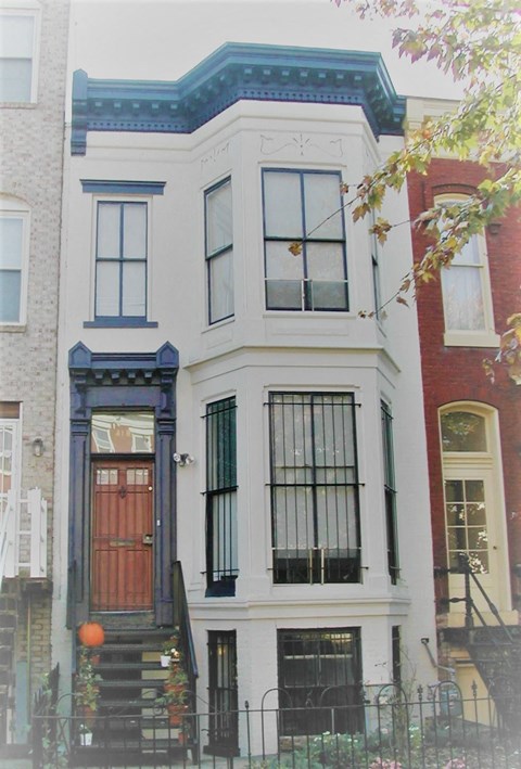 the front of a house with a red door
